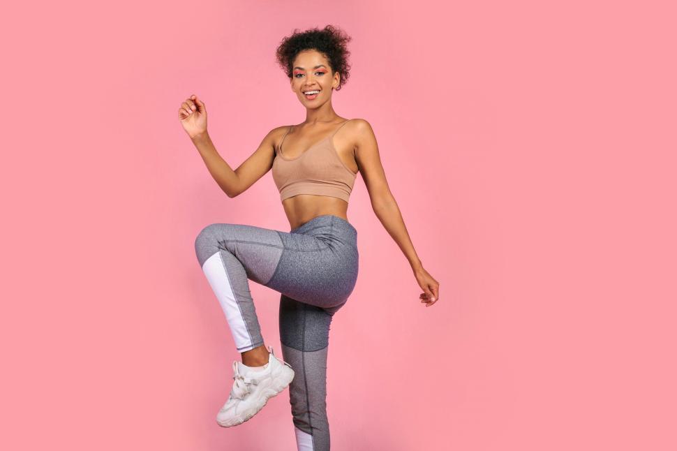 Free Image of Fitness model with raised leg 