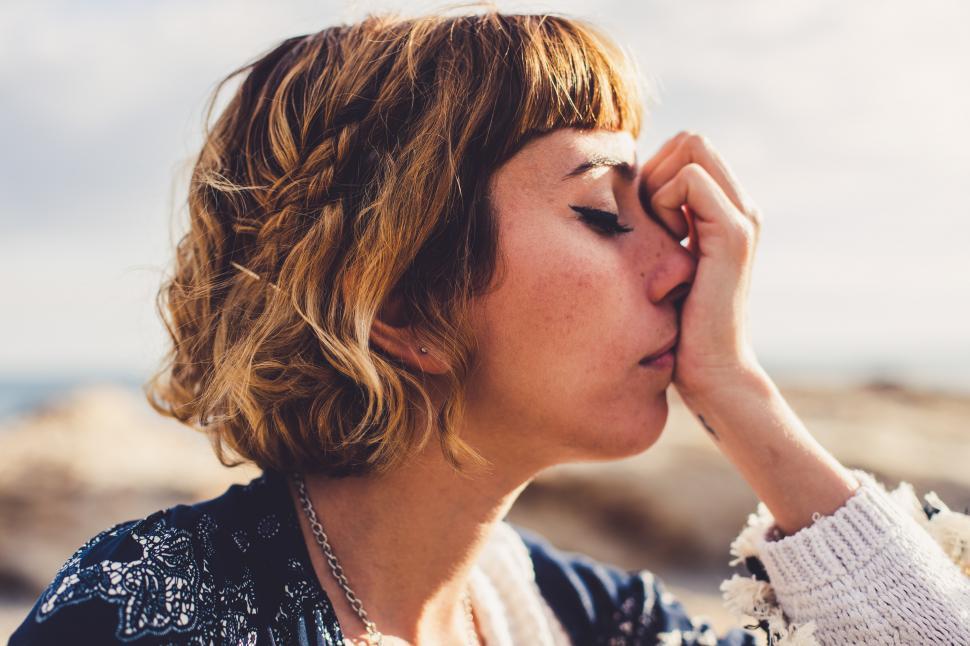 Free Image of boho model posing with hand to face 