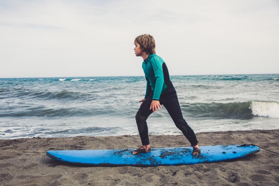 Free Image of a young kid learning to surf 