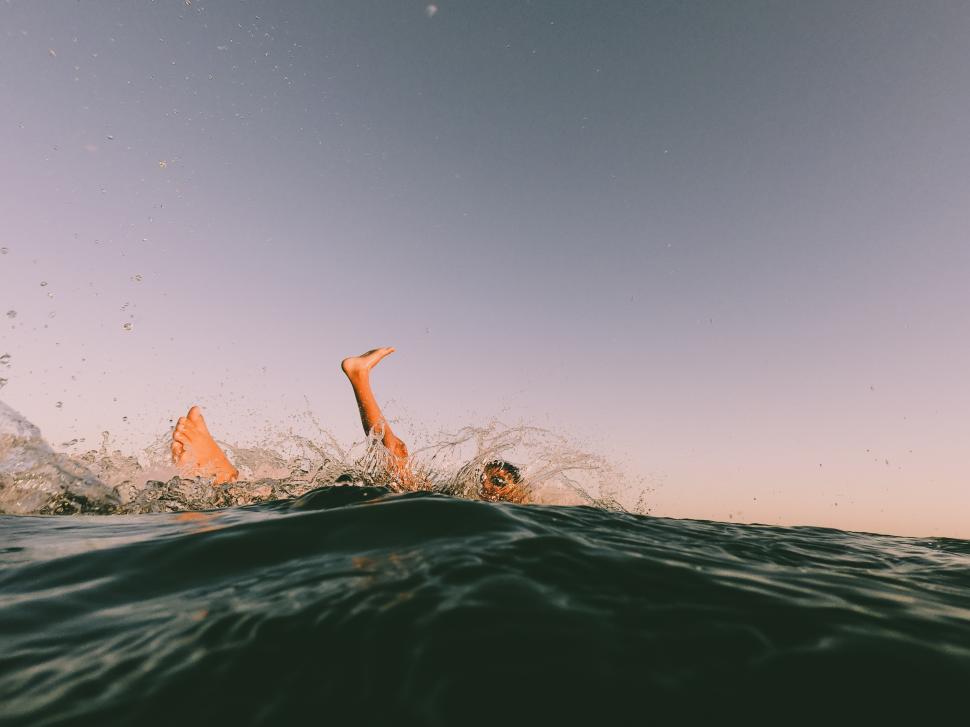 Free Image of a young kid splashing in the ocean 