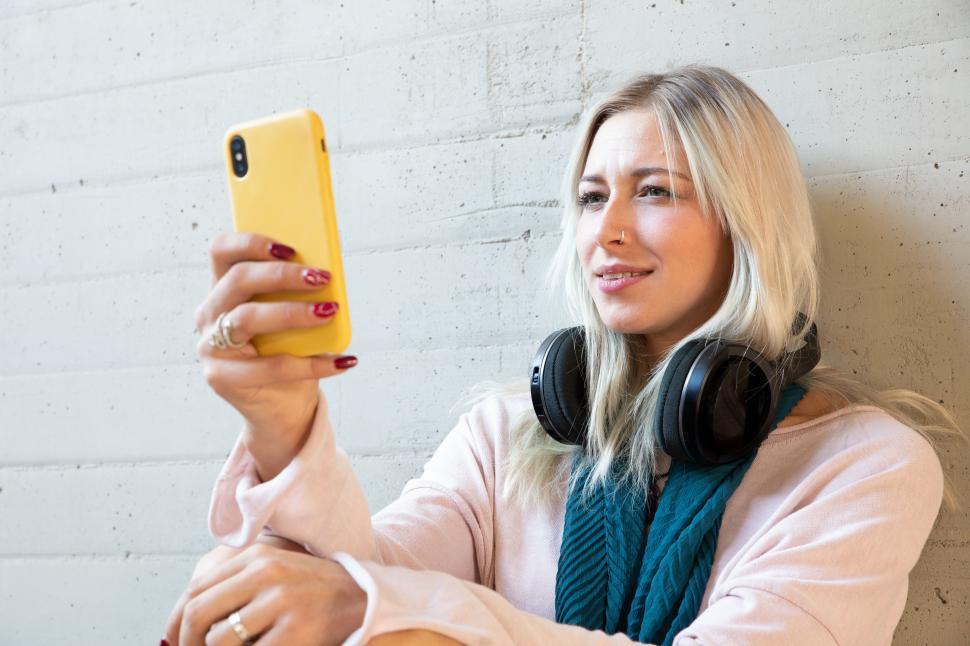 Free Image of Young woman having a rest and checking her smartphone 