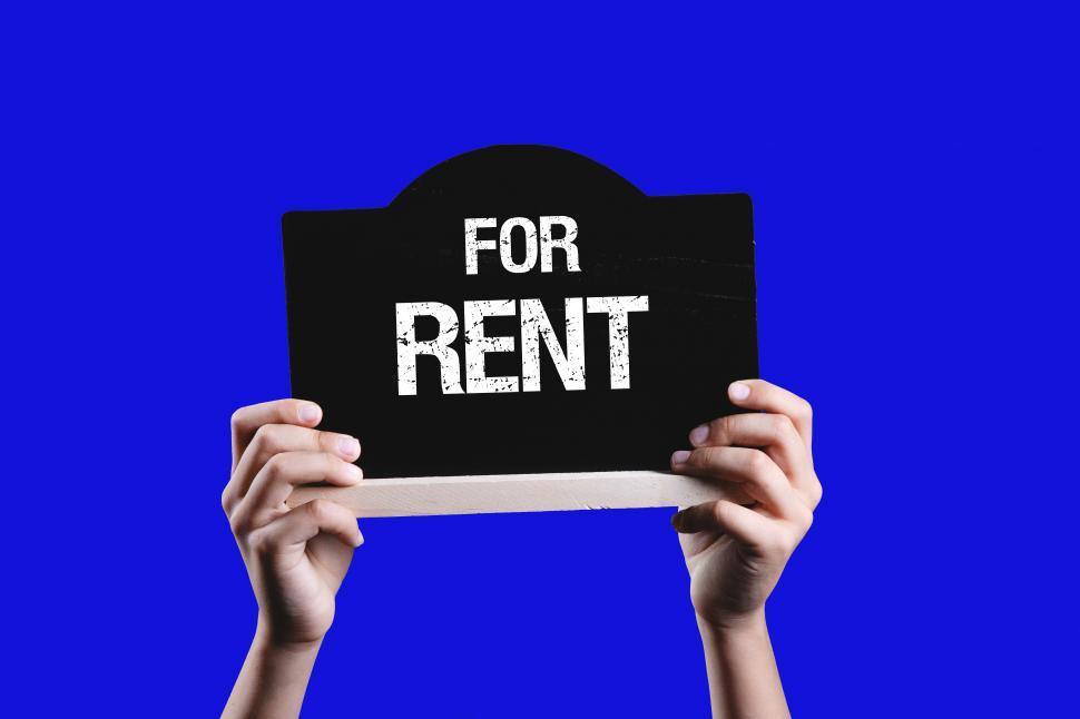 Free Image of Hands holding FOR RENT sign 