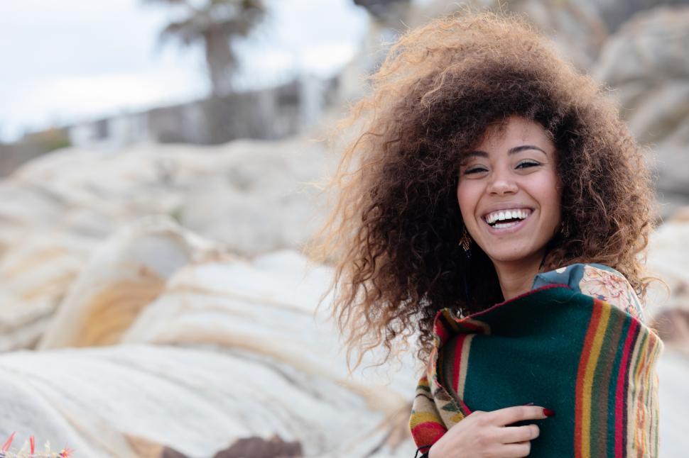 Free Image of Portrait of a young woman looking at the camera, outdoors in breeze 