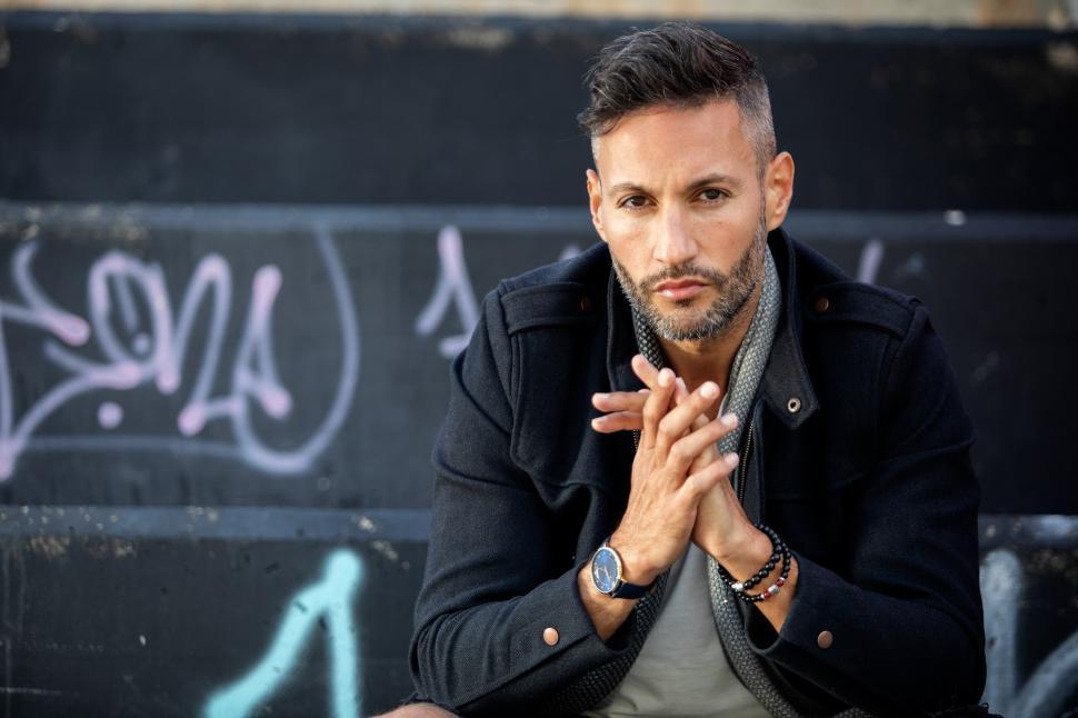 Free Image of a handsome young trendy man posing in a urban background 