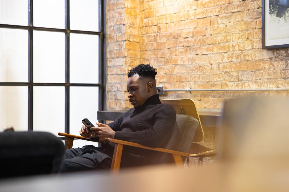 Free Image of African American young man using smartphone 