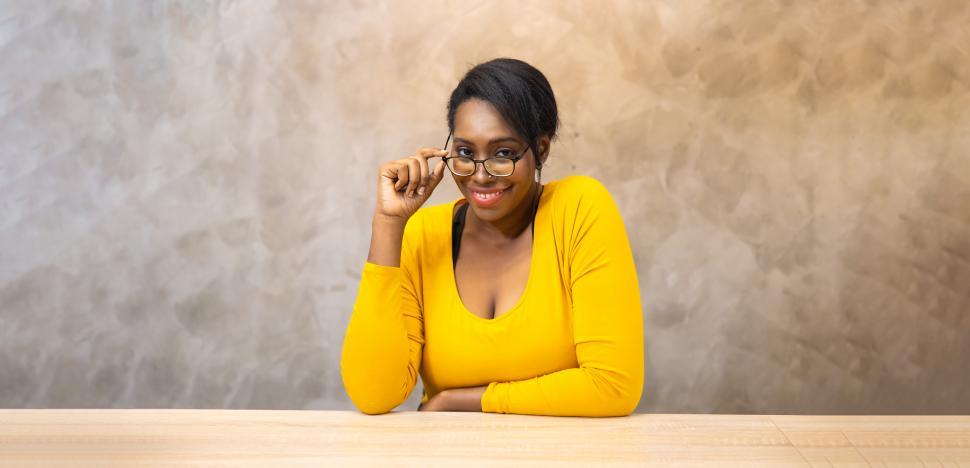 Free Image of Black woman looking over eyeglasses 