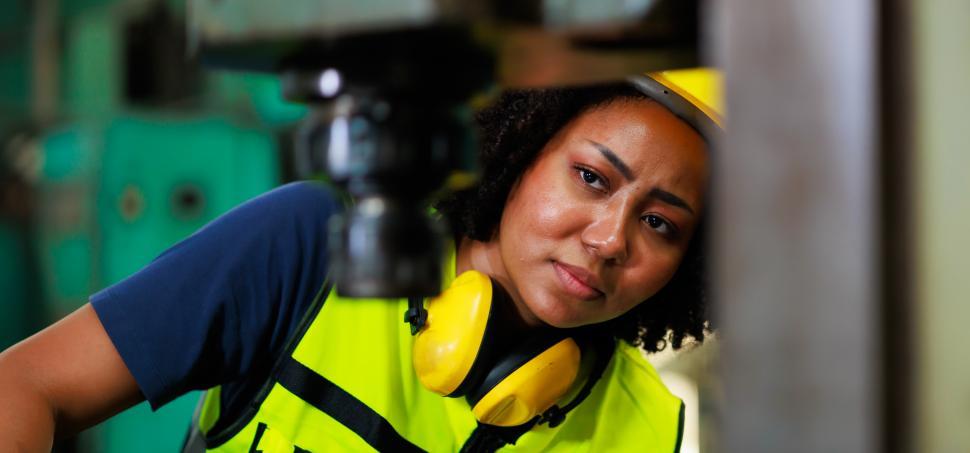 Free Image of Woman operating factory machinery 