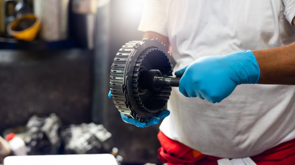 Free Image of Mechanic working on transmission 