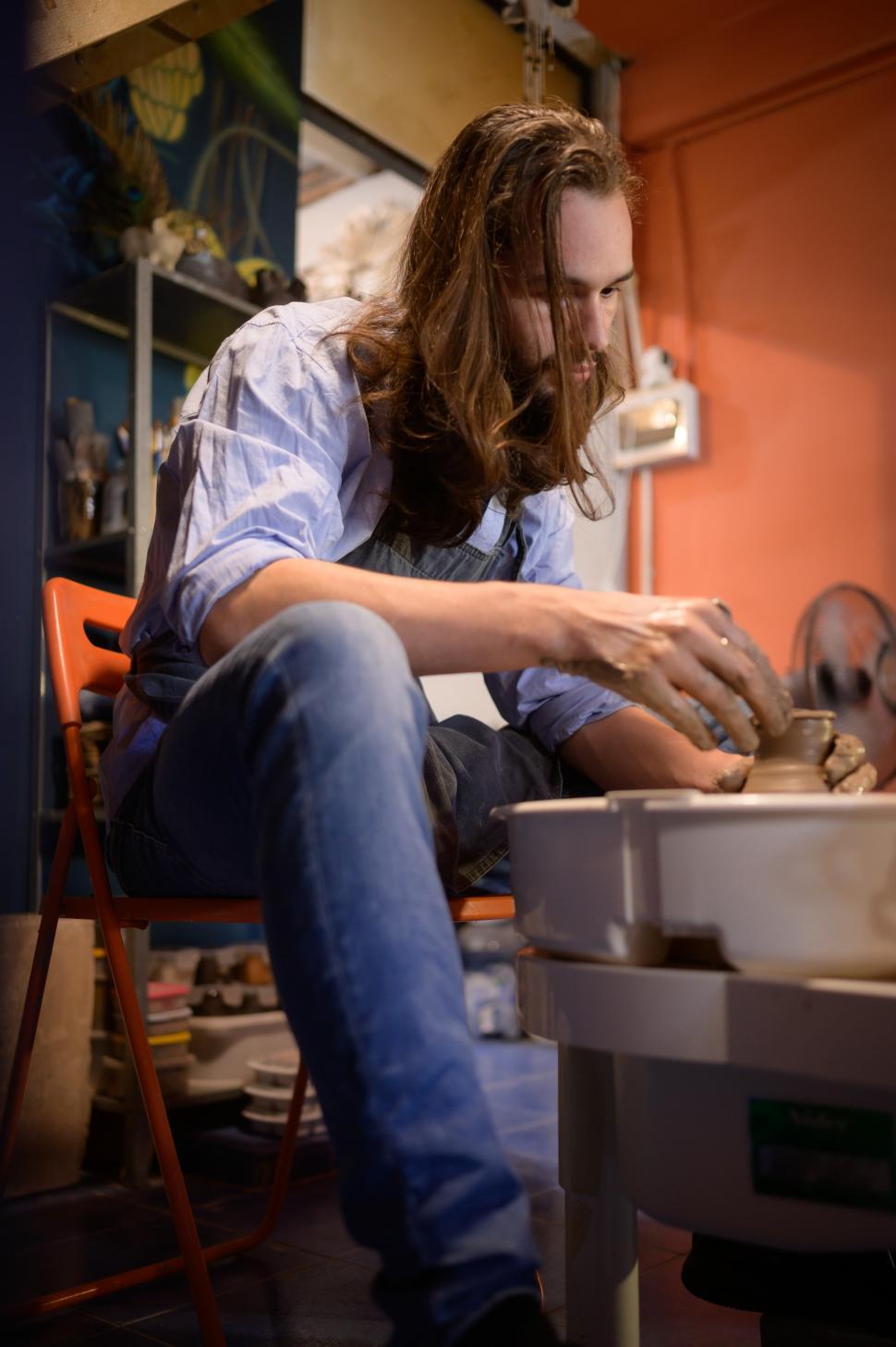 Free Image of Pottery artist throwing pot on a wheel 