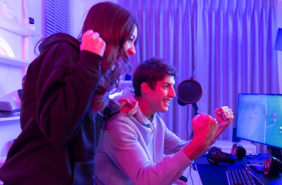Free Image of Two gamers or fans celebrating a victory 