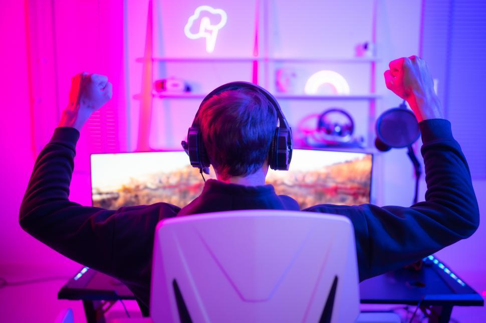 Free Image of Gamer holding his hands in the air after victory - or maybe defeat 