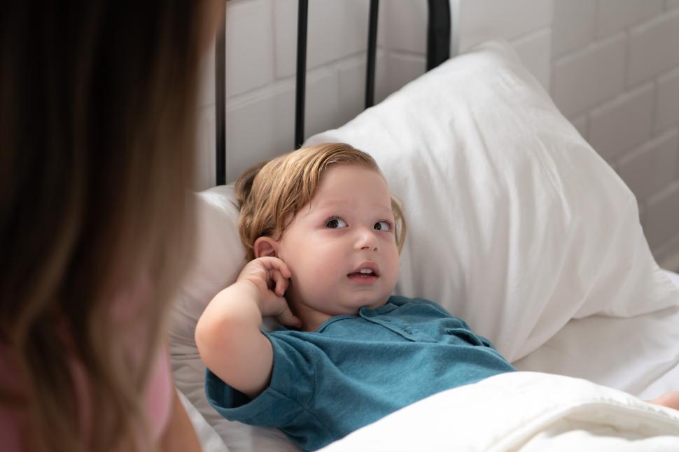 Free Image of Mother reads stories to a little boy before going to bed 