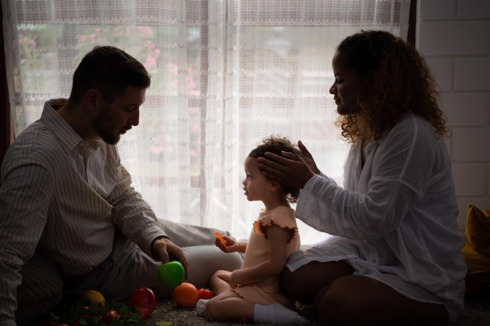 Free Image of Parents and children relax in the living room of the house with some toys 