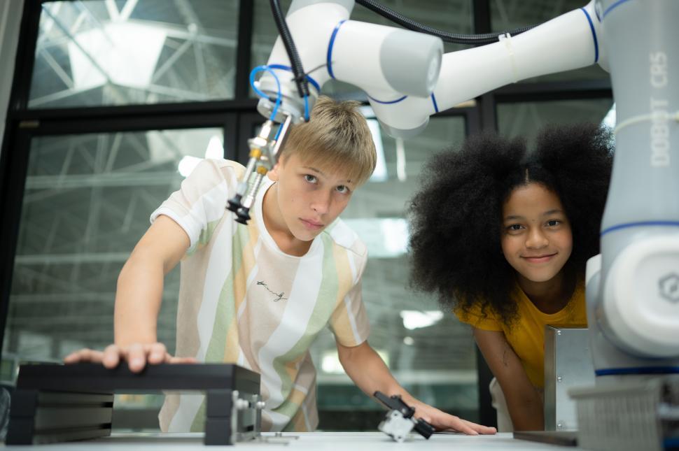 Free Image of Kids learning about robotics in a group technology lab. STEM programs in action. 