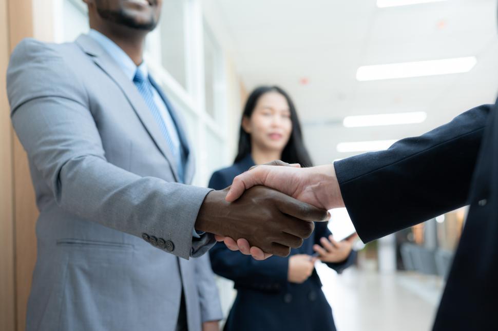 Free Image of Business people shake hands to show cooperation, achievements, or congratulations 