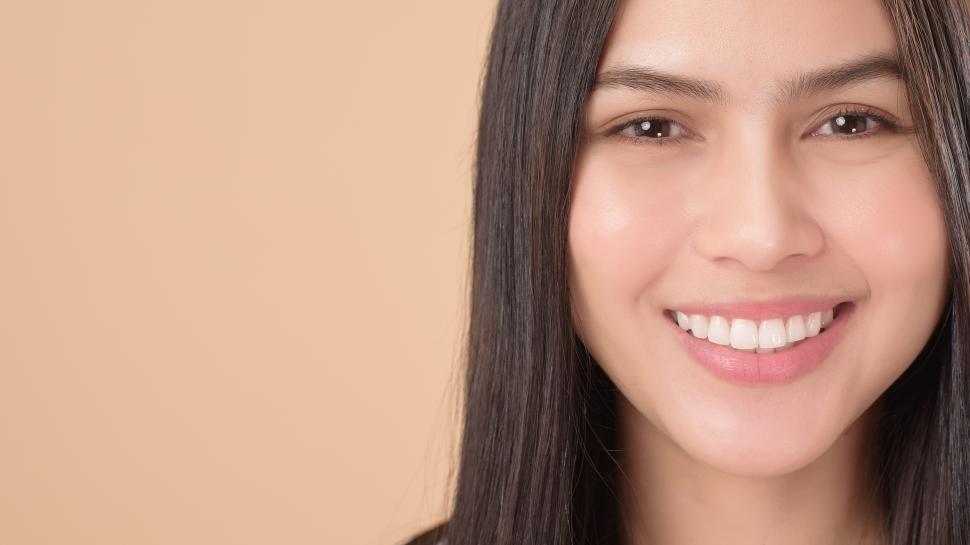 Free Image of Close up portrait of smiling Asian woman with copyspace 