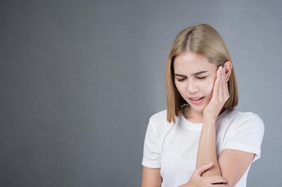Free Image of woman with a toothache, sensitive teeth or jaw pain 
