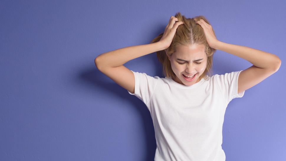 Free Image of portrait of stressed and depressed woman clutching her hair 