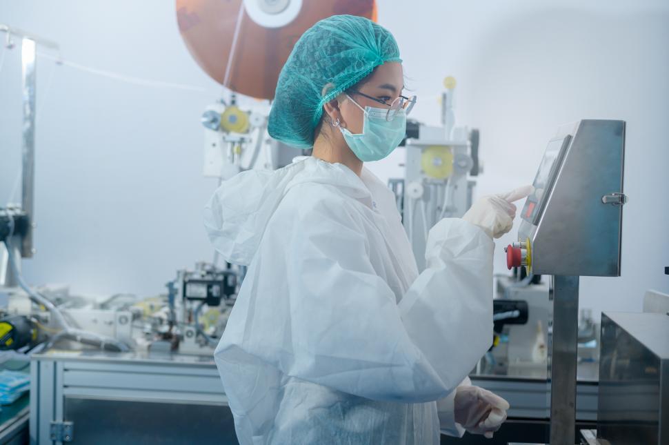 Free Image of Worker producing surgical masks - factory production line 