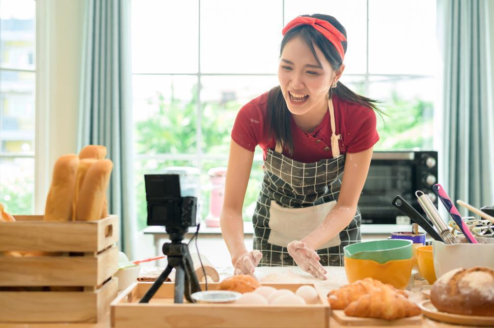 Free Image of Woman life streaming the process of baking from scratch in her kitchen 