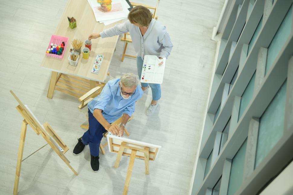 Free Image of Artists painting together in bright open studio 