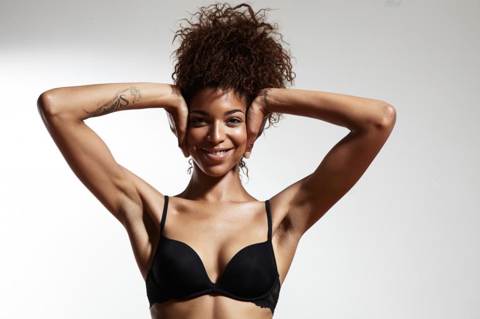 Free Image of Stong, fit woman covering her ears with her hands, facing camera 