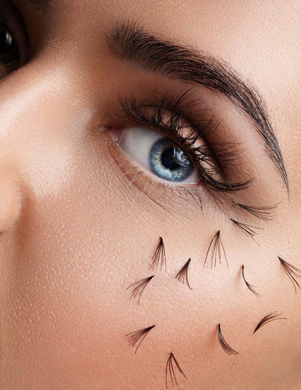 Free Image of closeup of womans eye with falling eyelashes down her cheek 
