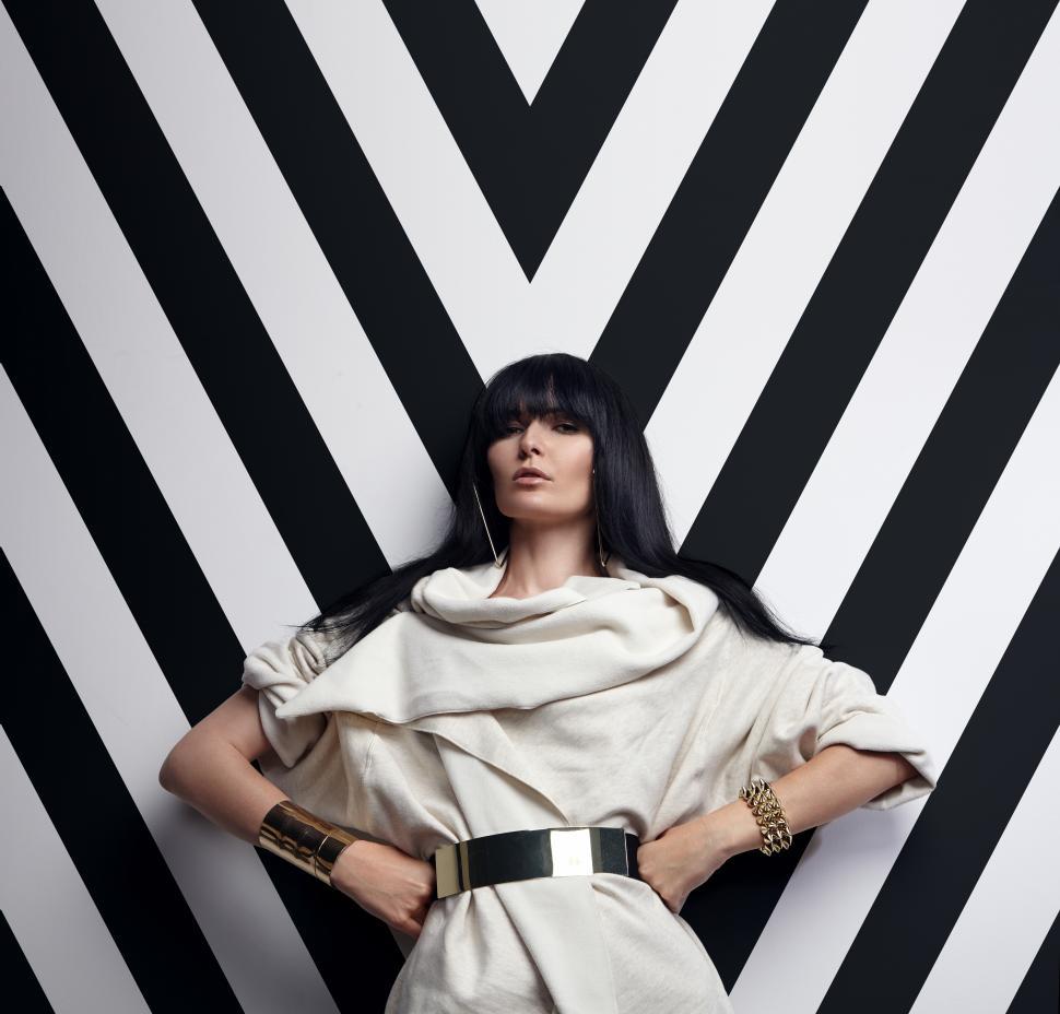 Free Image of strict woman  with dark hair on the graphic background in studio 