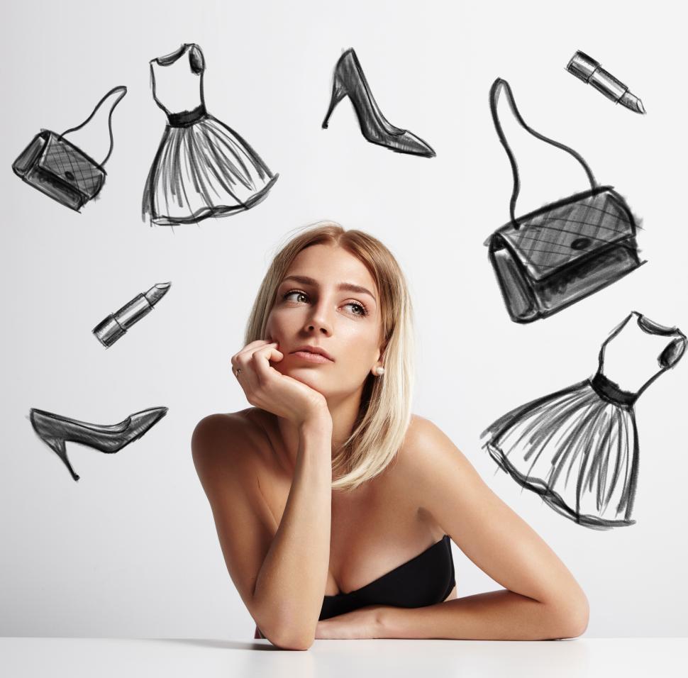 Free Image of woman with a drawn dress, shoes, lipstick and bag circling her head 