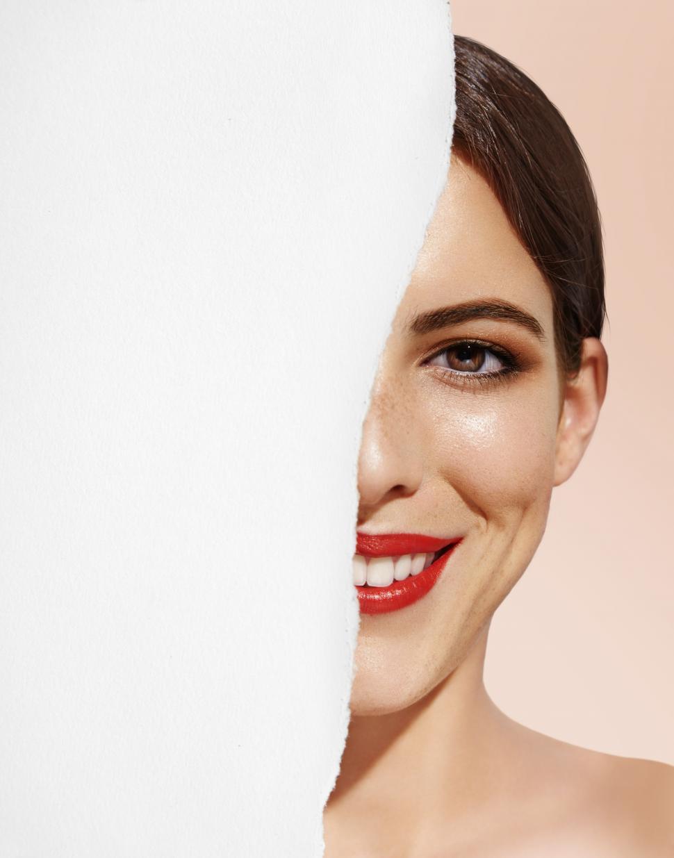 Free Image of Half a womans face on torn background - ripped in half 