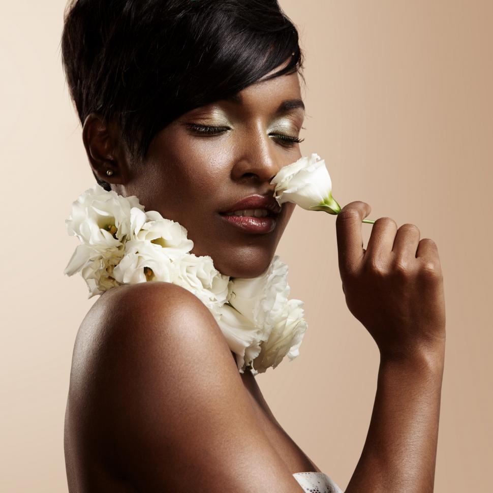 Free Image of Attractive woman sensually sniffing a flower 