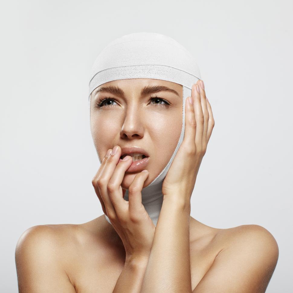 Free Image of young woman bandaged and feeling pain after cosmetology surgery 