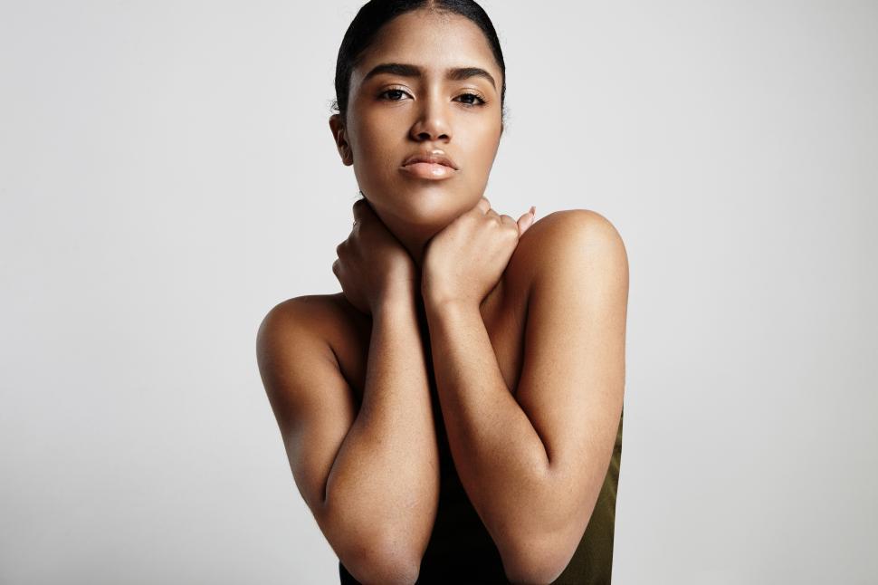 Free Image of beautiful latin woman holding her neck in arms 