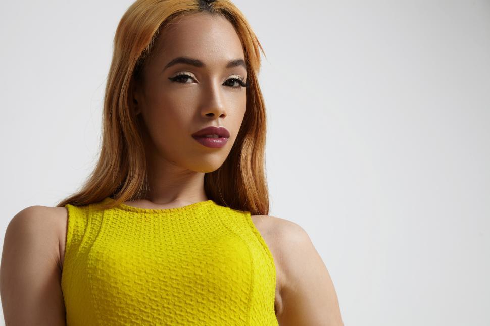 Free Image of blonde mixed race woman in bright yellow top 