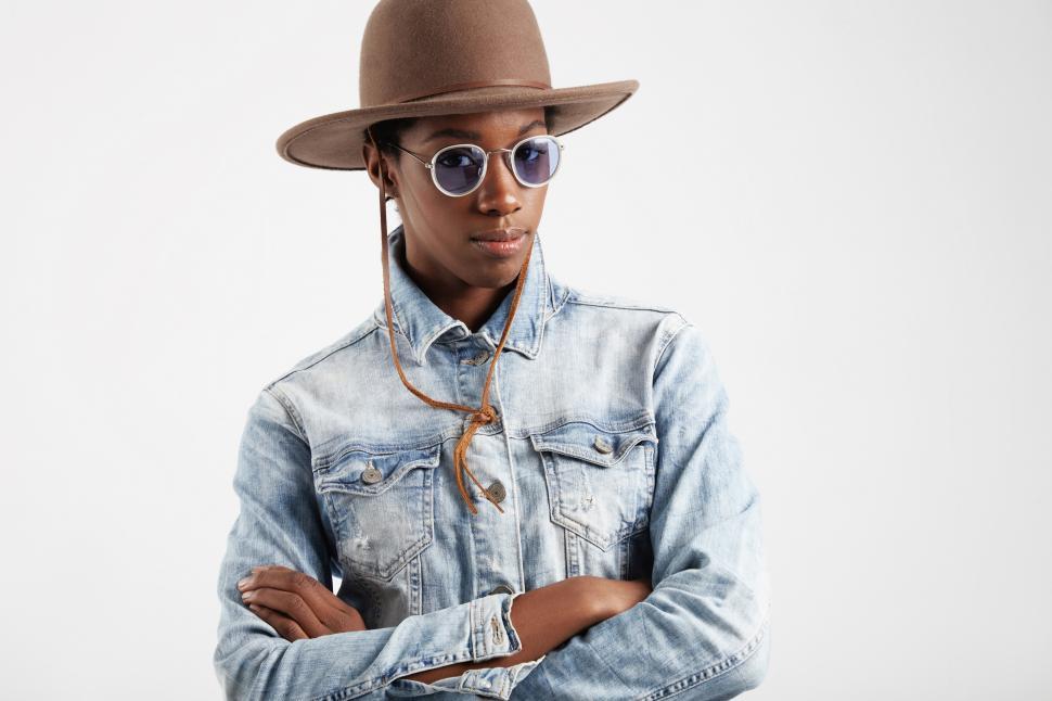 Free Image of western style black woman in blue colored glasses with arms crossed 