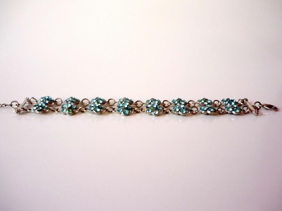 Free Image of Silver Bracelet With Blue Beads on White Background 