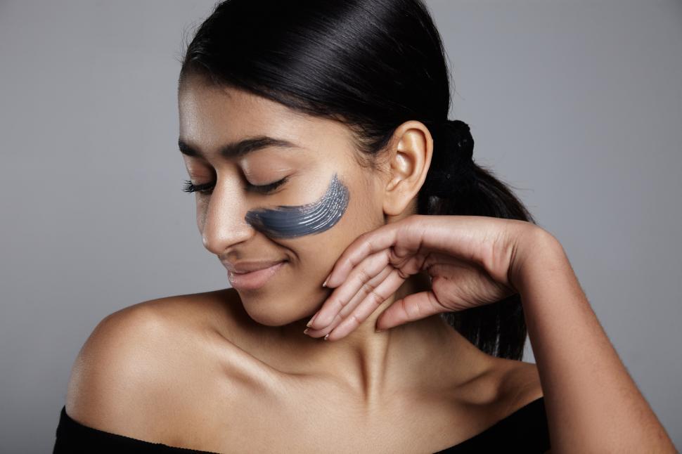 Free Image of woman with streak of cream on her face 