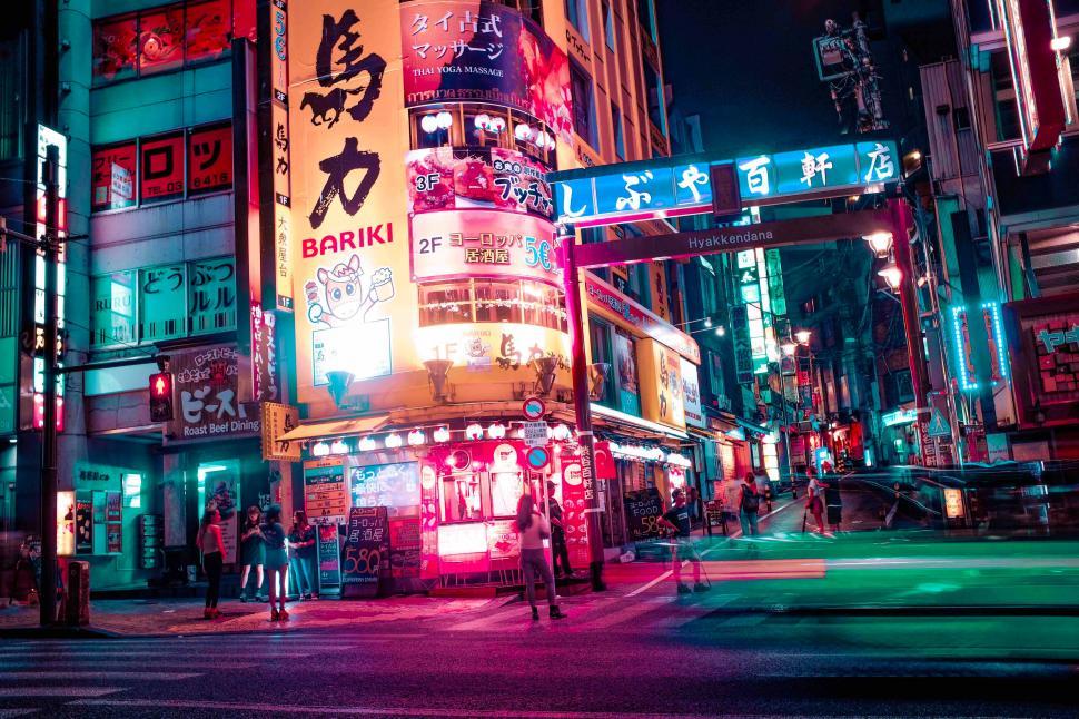 Free Image of A street with signs and people in the city 
