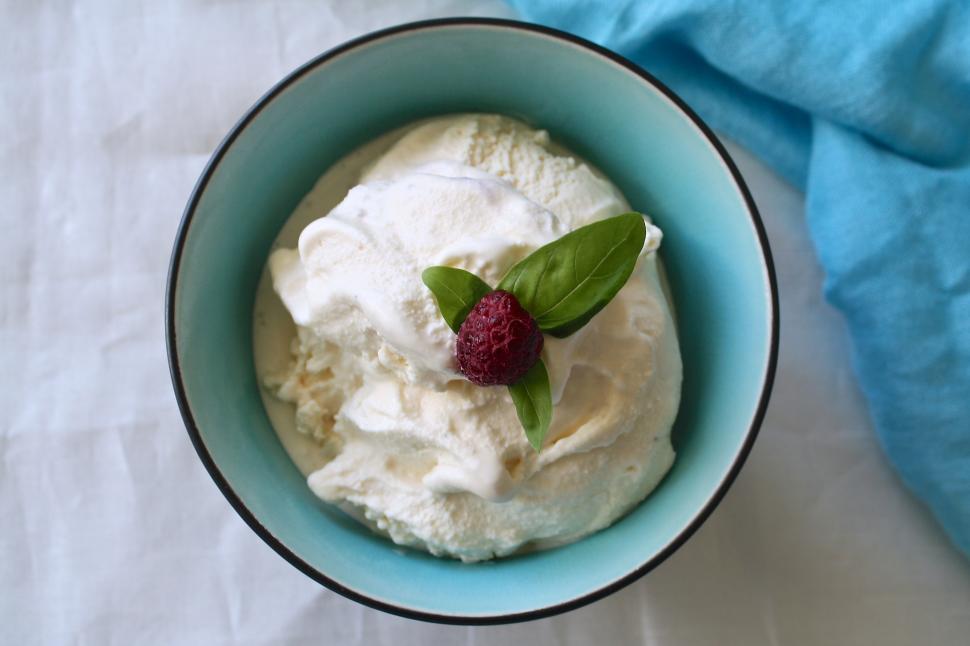 Free Image of A bowl of ice cream with a raspberry on top 