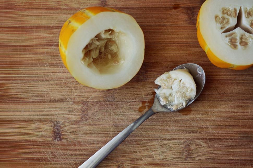 Free Image of A melon with a spoon and a piece of food 