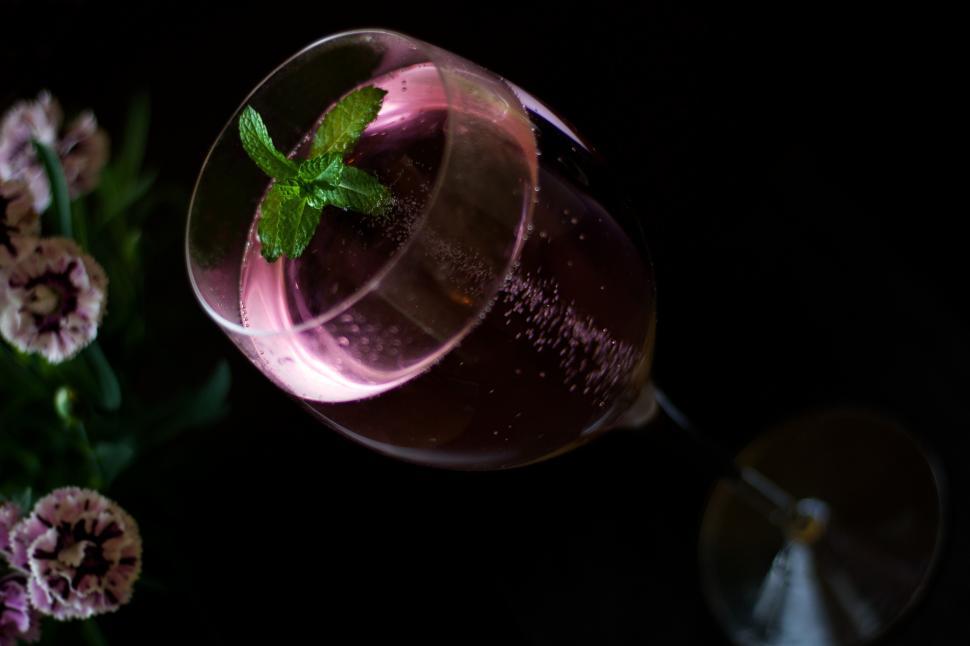 Free Image of A glass of wine with a leaf on top 