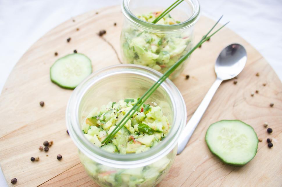 Free Image of A couple jars of food on a wooden surface 