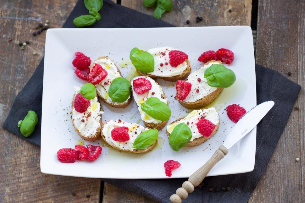 Free Image of A plate of food with raspberries and basil on it 