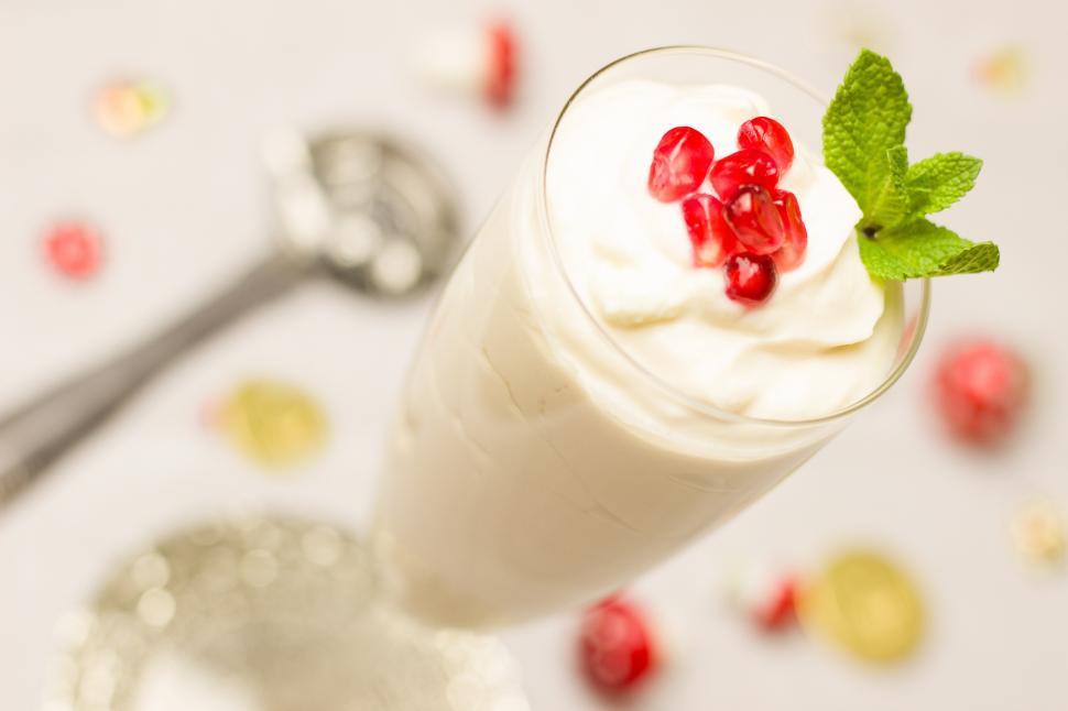 Free Image of A glass with a white drink and a green leafy leaf 