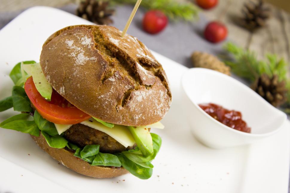 Free Image of A burger with a toothpick on it 