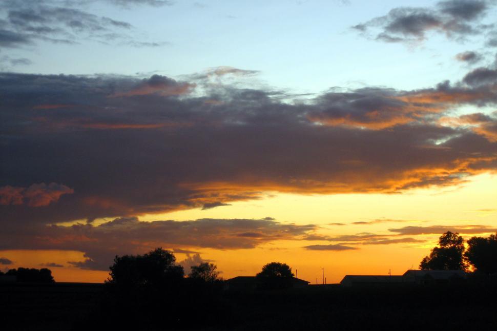 Free Image of Sun Setting Over Field With Trees 