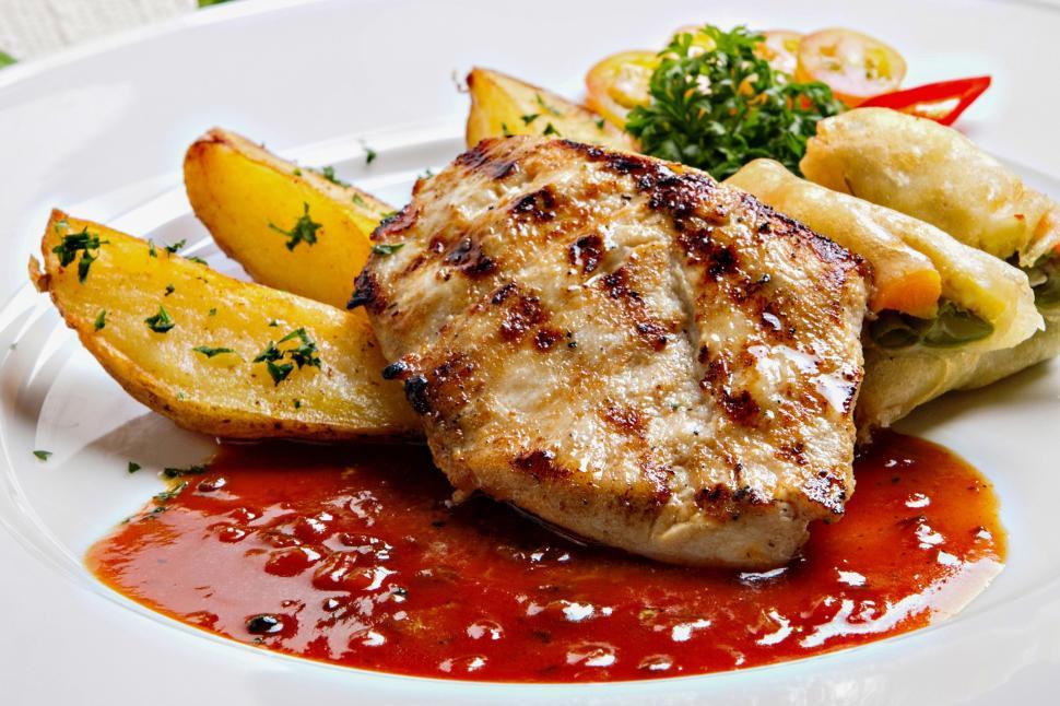 Free Image of A plate of food with sauce and potatoes 