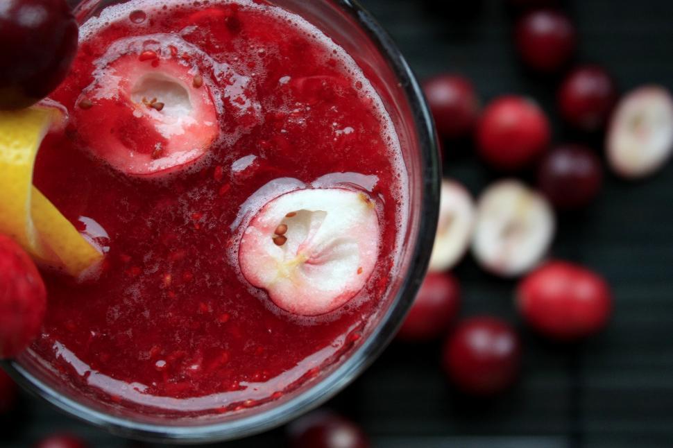 Free Image of A glass of red liquid with fruit slices in it 