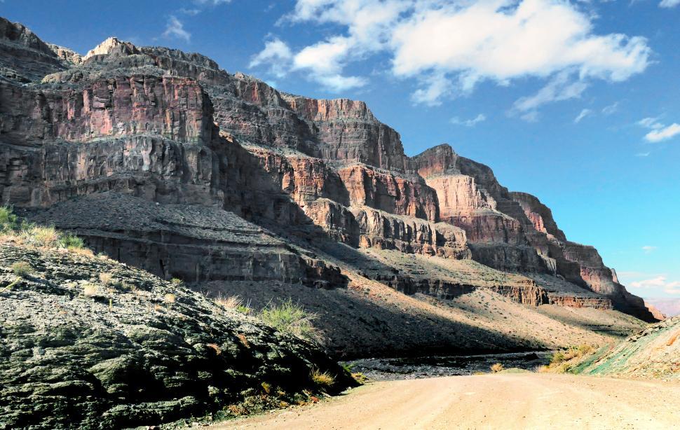 Free Image of A dirt road leading to a rocky mountain 