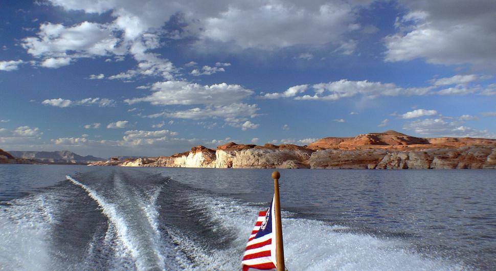 Free Image of A boat with a flag on the back of it 